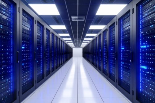 Data center hallway with rows of blue-lit server racks along a bright white tiled floor, converging at a distant white wall.