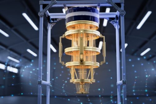 Gold-toned scientific instrument with copper windings mounted in a metal frame in a high-tech lab, blue ambient lighting in the background.